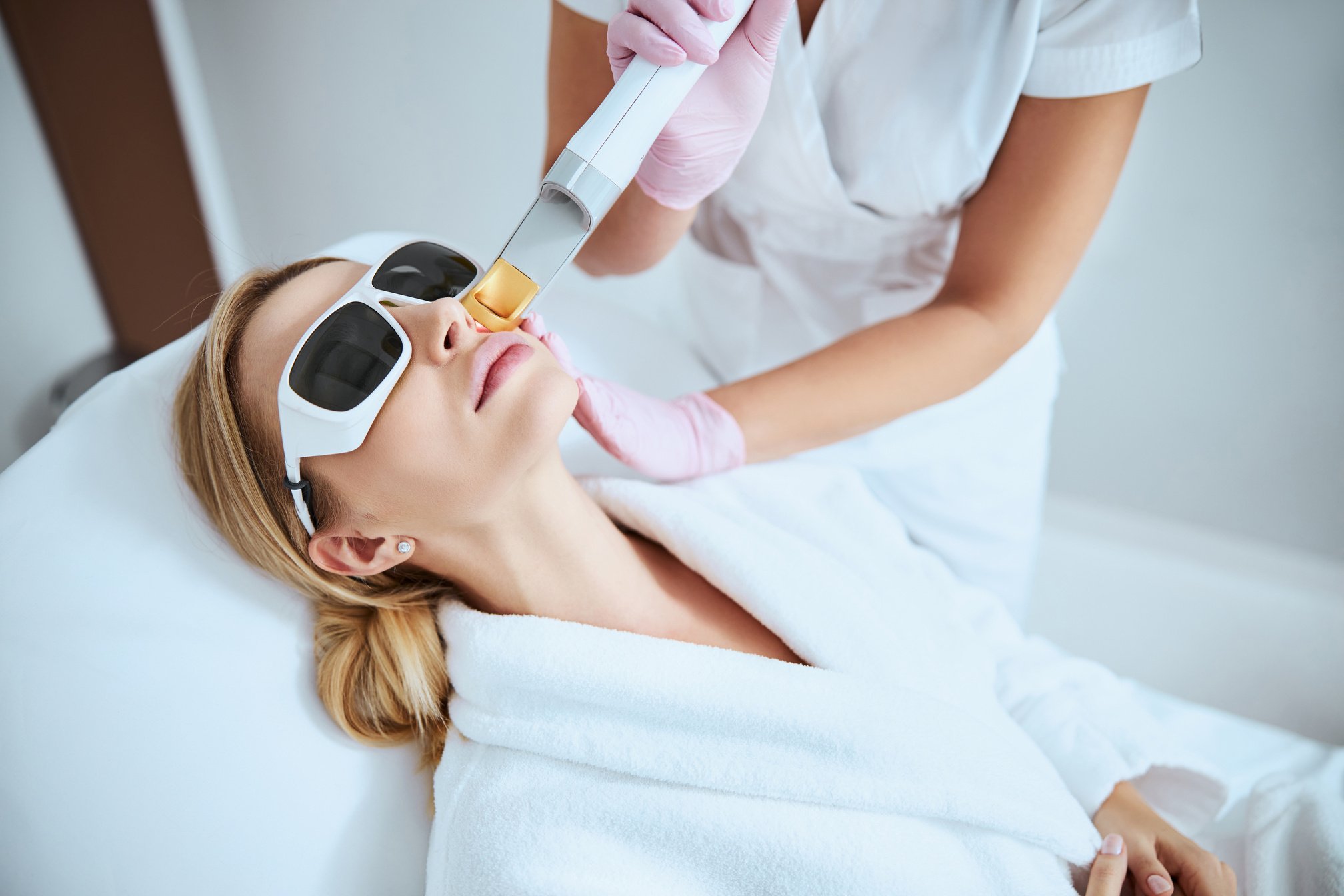 Woman undergoing the fractional laser skin treatment